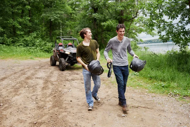 A couple of ATVers take a break from trail riding in Fort Ripley