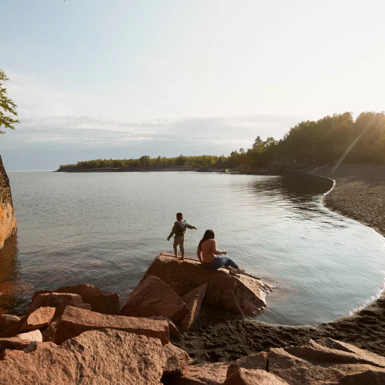 Mother and son play together by the shore of Lake Superior