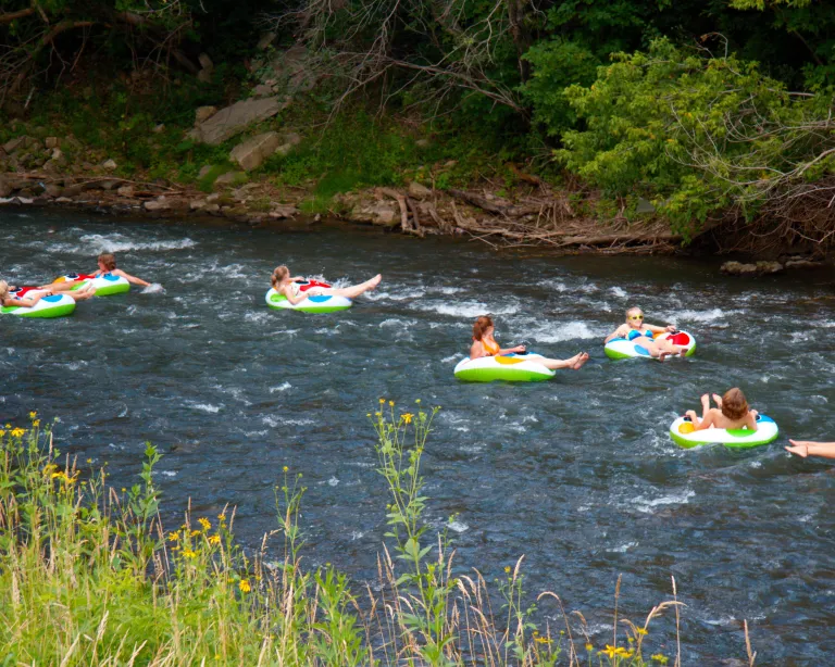 Seven women river tubing on the Root River in southern Minnesota
