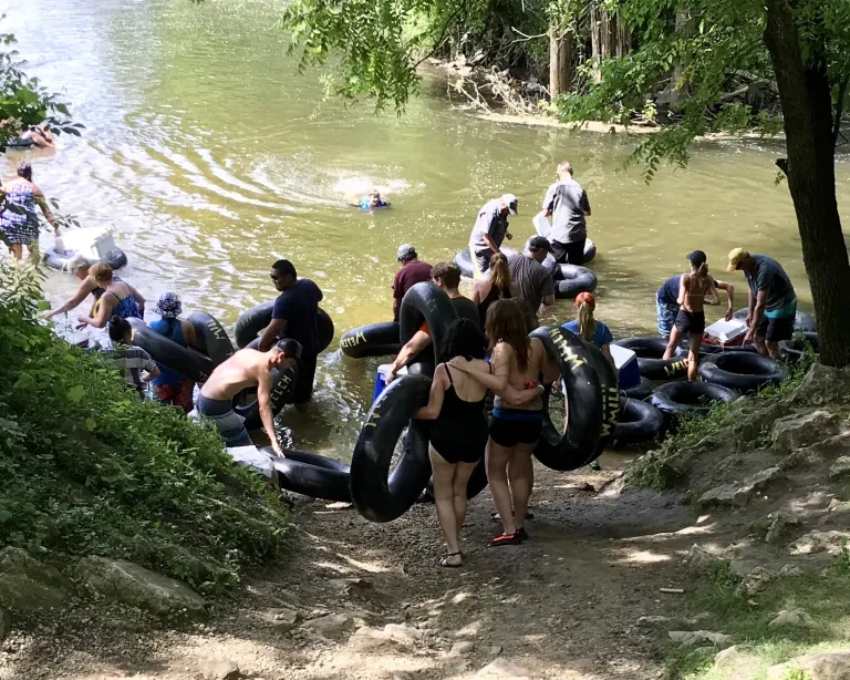 A crowd of people gets ready to start tubing the Cannon River