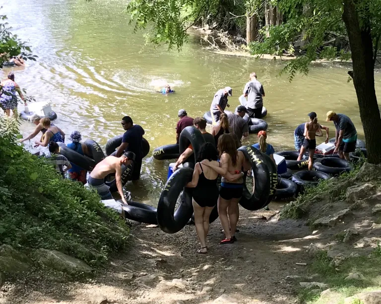 A crowd of people gets ready to start tubing the Cannon River