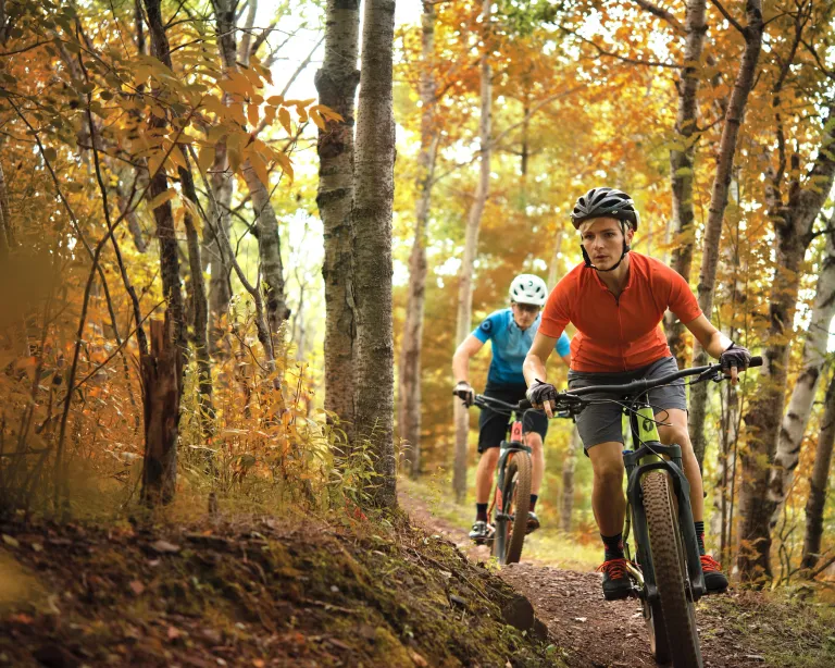 A couple goes mountain biking in Cuyuna during the fall