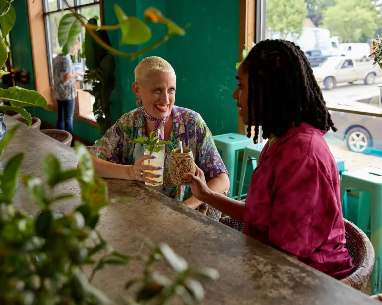 A couple toasts their tropical cocktails at Hai Hai